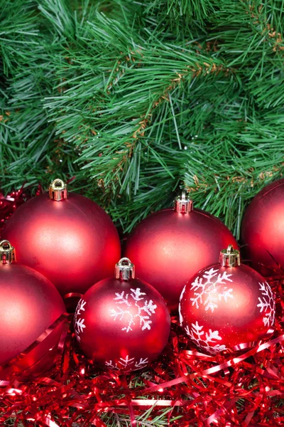 Several red Christmas baubles tinsel and Xmas tree — Φωτογραφία Αρχείου