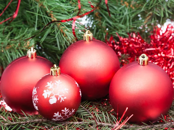 Few red Christmas baubles on Xmas tree background — Zdjęcie stockowe