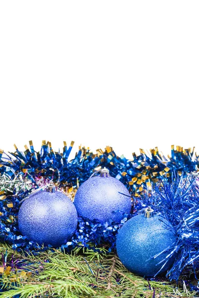 Blue Christmas baubles on green spruce tree branch — Stock Photo, Image