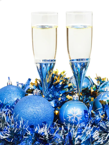 Glasses of champagne and blue Xmas ball and tinsel — Stock Photo, Image