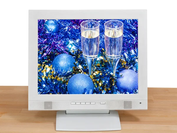 Blue baubles and glasses on screen of gray monitor — Stockfoto