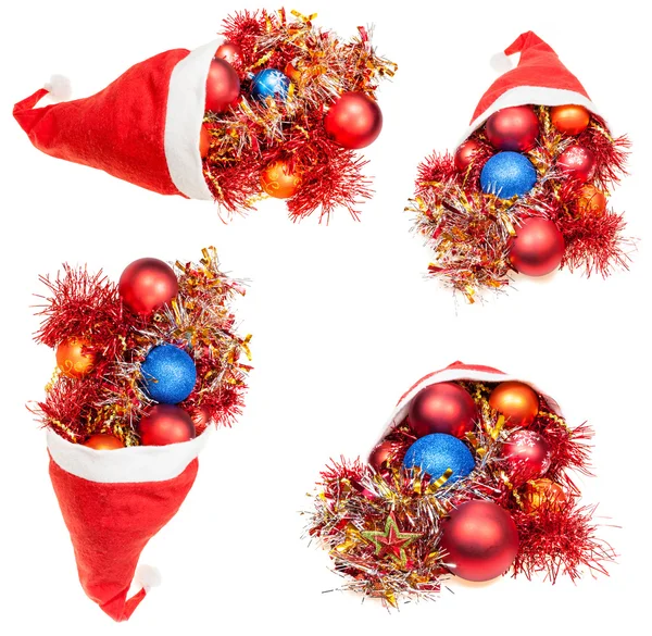 Four red santa hats with christmas decorations — Stockfoto