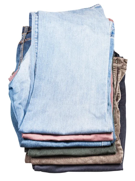 Bovenaanzicht van stapel verschillende jeans en ribbroek — Stockfoto