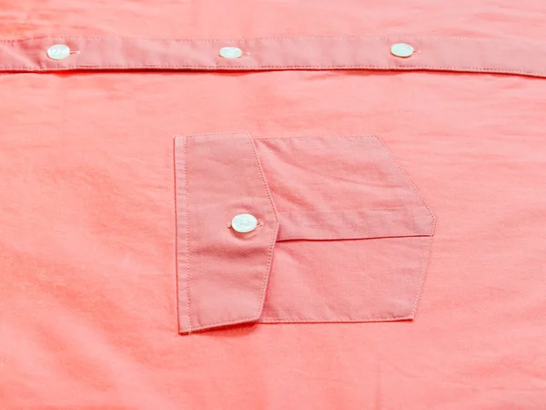 buttoned pocket of red shirt