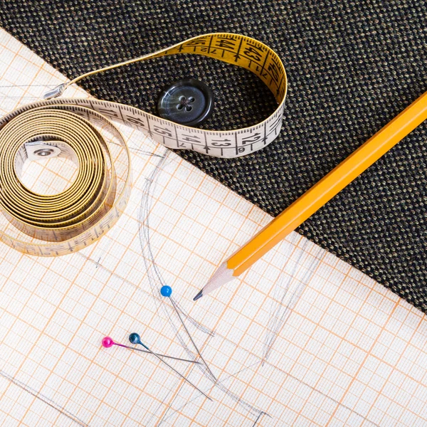 Pattern, measuring tape, pencil, pins, tweed coat — Stock Photo, Image