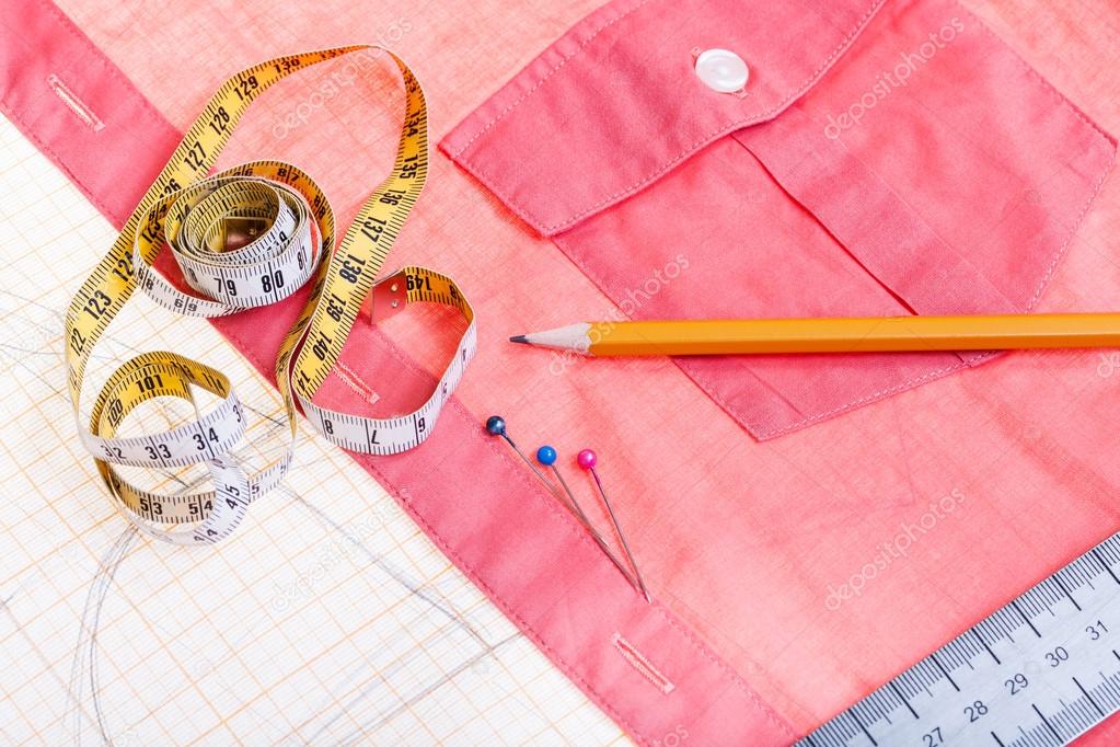 pattern, measure tape, pencil, pins, red shirt