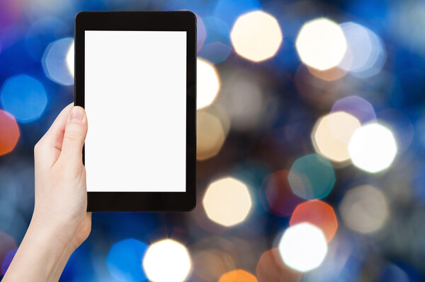 hand with tablet pc on blurred blue background