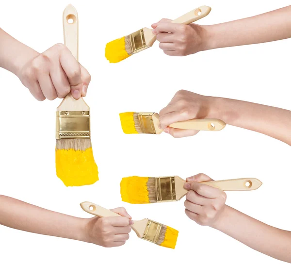 Set of hands with flat paint brush with yellow tip — Stock Photo, Image