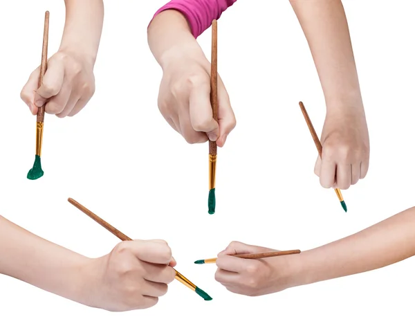 Set of hands with art paintbrushes with green tips — Stock Photo, Image