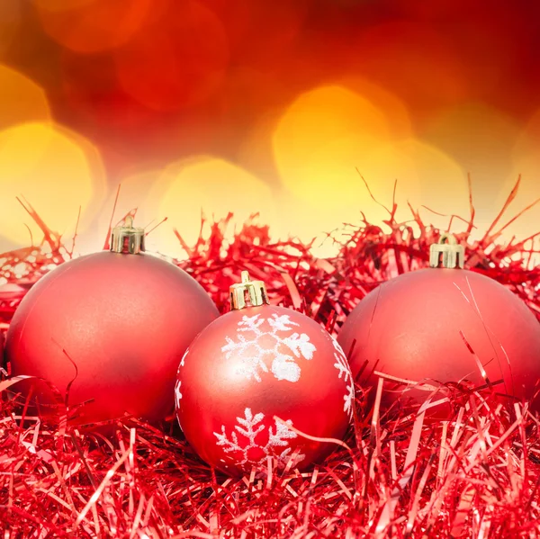 Xmas red balls on blurred red yellow background Stock Photo