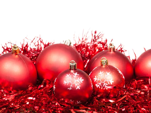 Several red Christmas balls and tinsel isolated — Stock Photo, Image