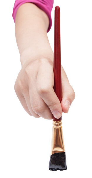 front view of hand with black art flat paint brush