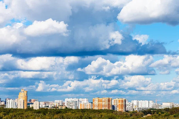 Lage wolken boven bossen en flatgebouwen — Stockfoto