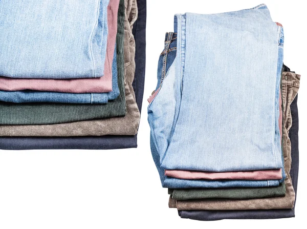 Set of stacks of various jeans and corduroys — Stock Photo, Image