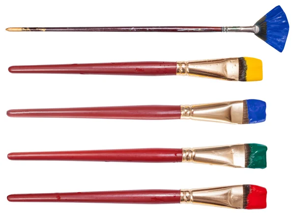 Set of flat artistic paintbrushes with painted tips — Stock Photo, Image