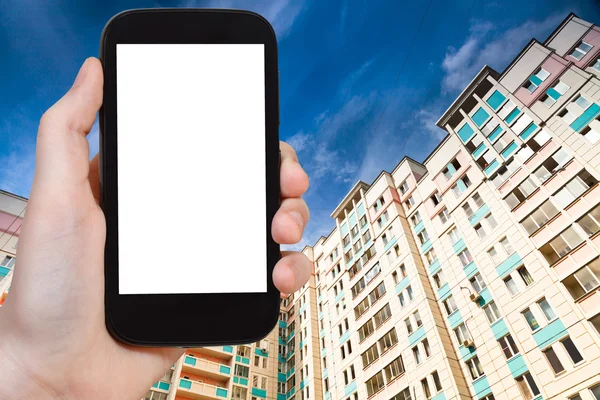 Smartphone with cut out screen and new houses — Stockfoto