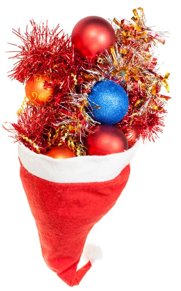 Bolas de xmas e decorações transbordar de santa hat — Fotografia de Stock