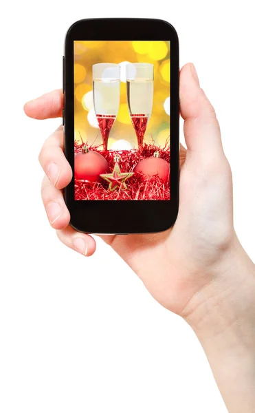 Hand holds telephone with Xmas still life — Stock Photo, Image