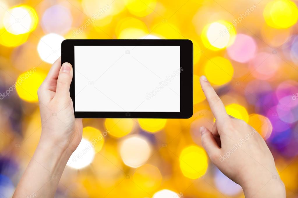 hand with tablet pc on yellow and blue background