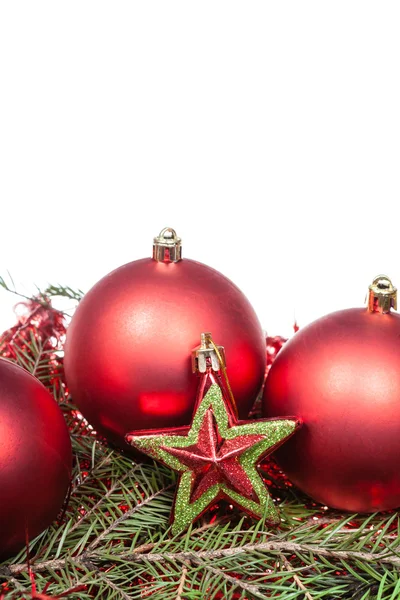 Star and red Christmas baubles on green spruce — Stock Photo, Image