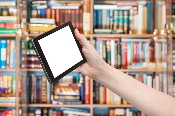 Hand holds tablet pc in library background — Stock Photo, Image