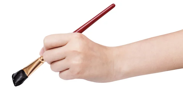 Ręka trzyma artystyczny pędzel płaski, z czarną końcówką — Zdjęcie stockowe