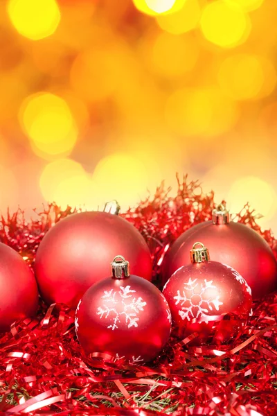 Xmas red baubles on blurred yellow background — Stock Photo, Image