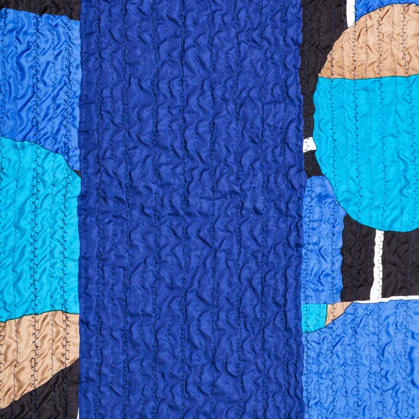 Stitched wrinkled blue silk fabric and patchwork — Stock Photo, Image