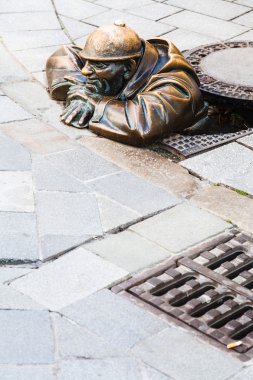 Bronze sculpture of Cumil the Peeper in Bratislava