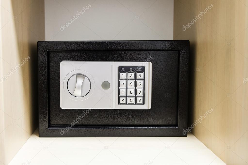 compact safe on shelf of cabinet