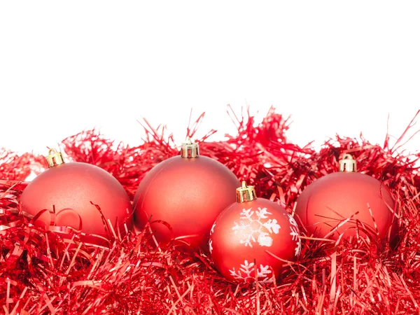 Few red Xtmas baubles and tinsel isolated — Stock Photo, Image