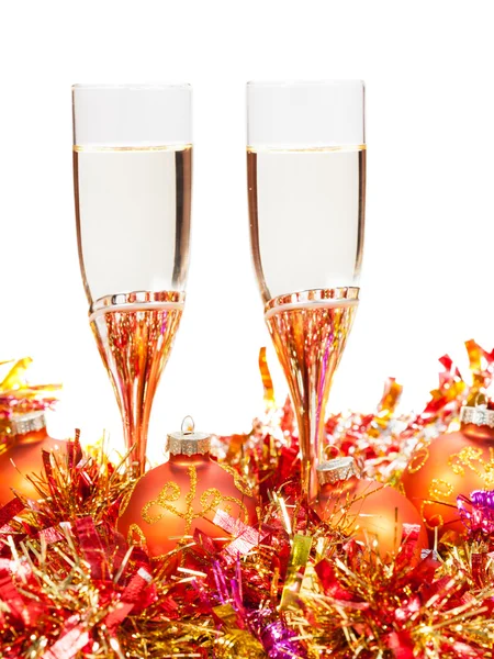 Glasses of sparkling wine and orange Xmas balls — Stock Photo, Image