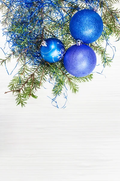 Blue Xmas decorations and twig on blank paper — Stock Photo, Image