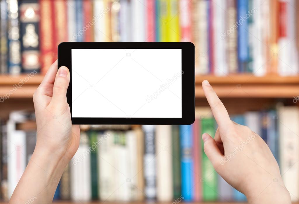 hand holds tablet pc and book shelves