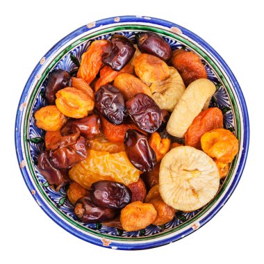 top view of dried fruits in ceramic bowl isolated clipart