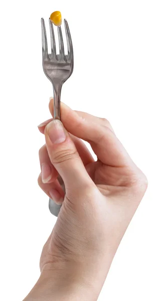 Yellow corn seed impaled on fork in female hand — Stock Photo, Image