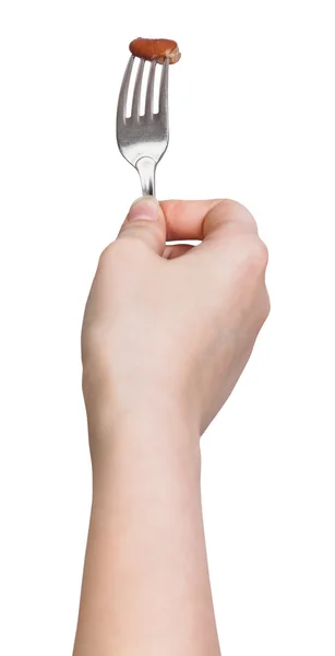 Hand holds dinning fork with impaled one brown bob — Stock Photo, Image