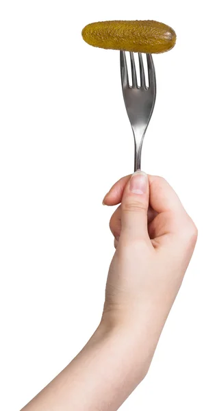 Pickled cucumber impaled on fork in female hand — Stock Photo, Image