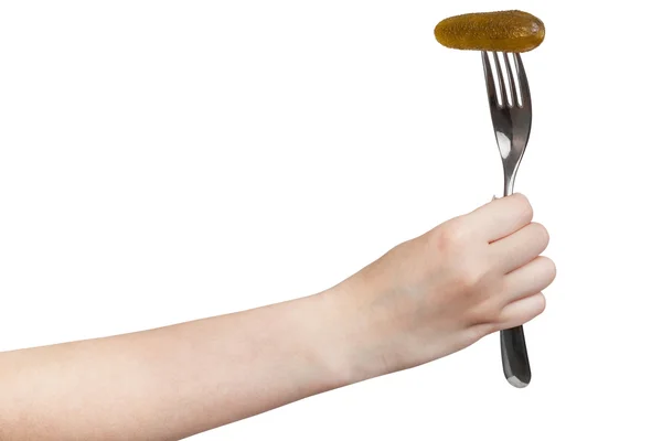 Hand holds fork with impaled pickled gherkin — Stock Photo, Image