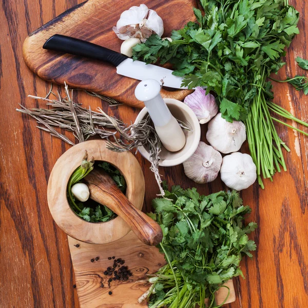 Draufsicht auf Mörser und würzige Kräuter auf Holztisch — Stockfoto