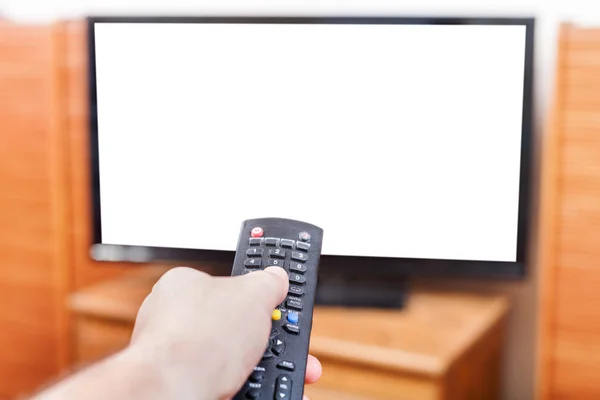 Hand switches TV channels with cut out screen — Stock Photo, Image