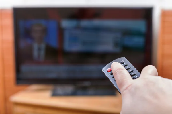 Turn off News on TV channel by remote control — Stock Photo, Image