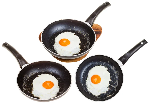 Set of frypans with one fried egg isolated — Stock Photo, Image