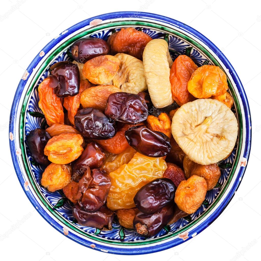 above view of dried fruits in bowl isolated