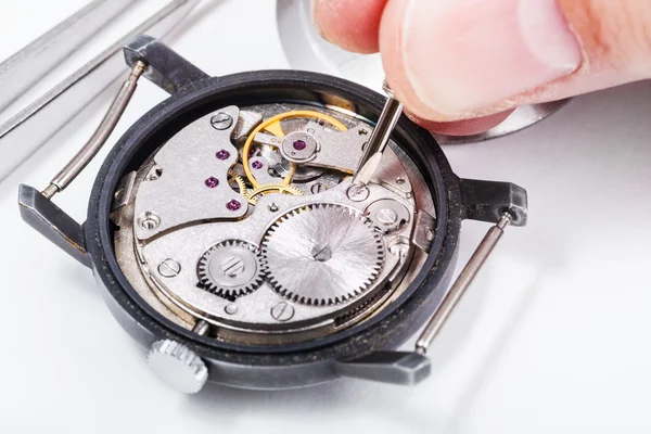 horologist repairs old watch close up