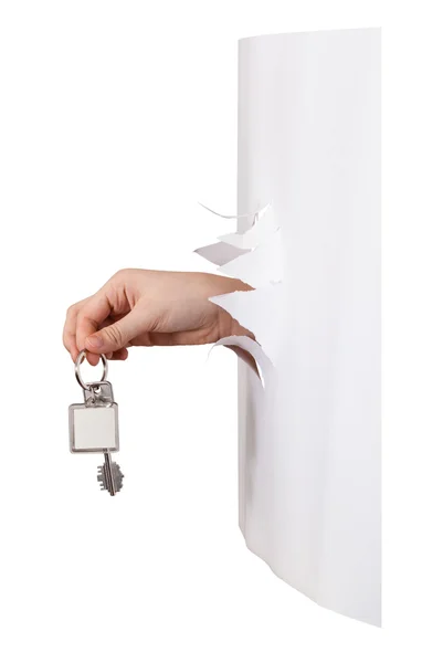 Side view of hand holds the keyring through a hole — Stock Photo, Image