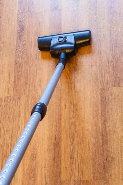 Above view vacuuming of parquet by vacuum cleaner — Stock Photo, Image