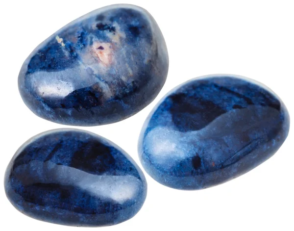three Dumortierite gemstones isolated on white