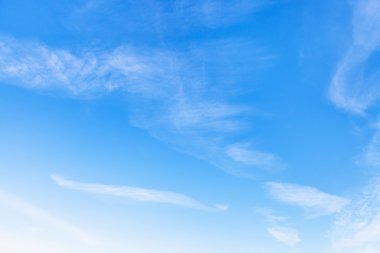 cirrus white clouds in blue sky in winter clipart
