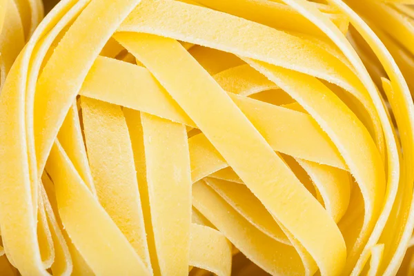 Durum wheat semolina pasta fettuccine close up — Stock Photo, Image